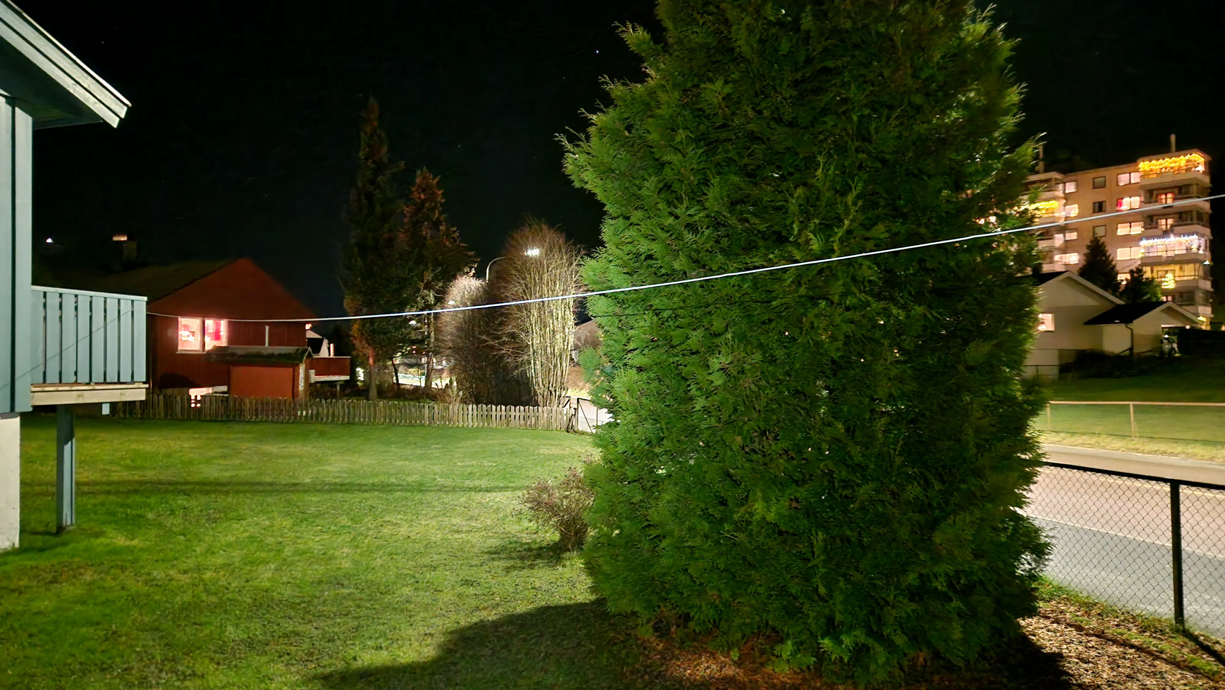 A wire antenna going from a tree to the balcony.